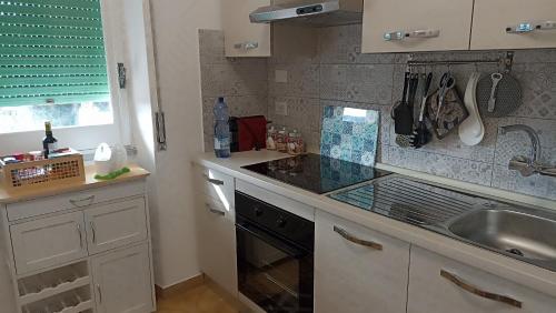 una cucina con lavandino e piano di lavoro di Carloforte Appartamento con Vista IUN R2015 a Carloforte