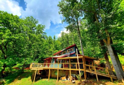 a tree house in the middle of the forest at Zen River Retreat in Stanardsville