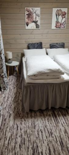 a bedroom with a bed and a wooden wall at Sydalen house in Kleppstad