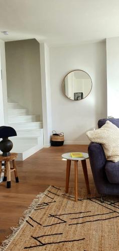 a living room with a blue couch and a table at The South Suite - trendy duplex op het Zuid in Antwerp