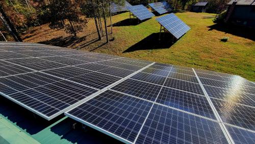 an array of solar panels on top of a house at Shire Suite at White Lotus Eco Spa retreat in Stanardsville