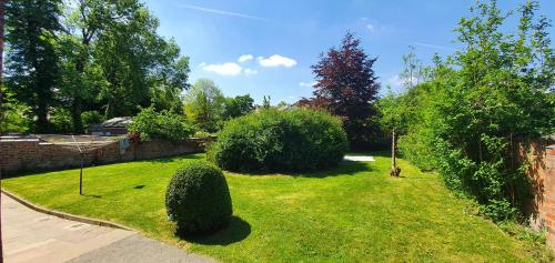 a garden with bushes and trees in a yard at Do not book, property being removed from site in Manchester