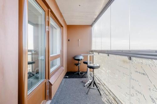 a room with a bar with stools next to a window at Tampere City view near Nokia Arena AC in Tampere