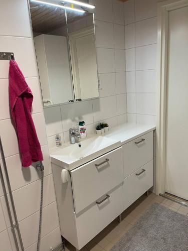 a bathroom with a white sink and a mirror at Tampere City view near Nokia Arena AC in Tampere