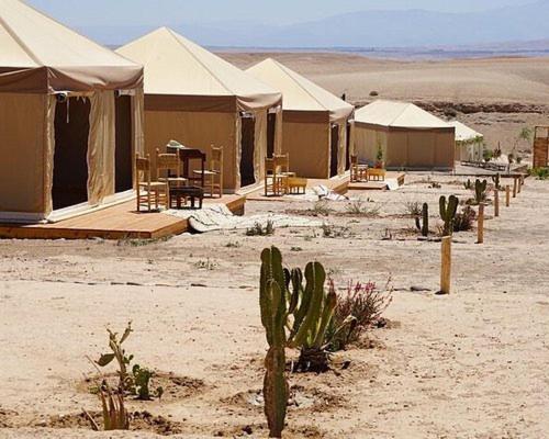 un groupe de tentes dans le désert avec des cactus dans l'établissement خيام للكراء ومكان رائع, à Agadir