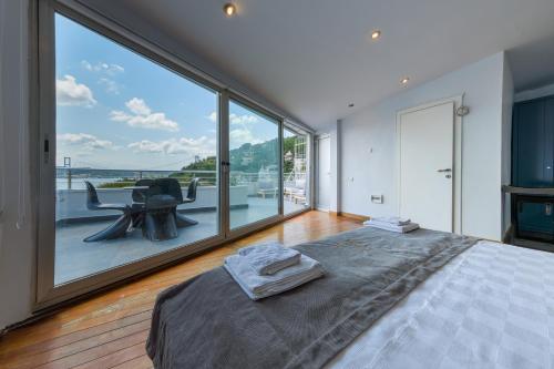 a bedroom with a bed and a large window at Maison Détroit : Iconic 3Br Triplex w/ GREAT Views in Istanbul
