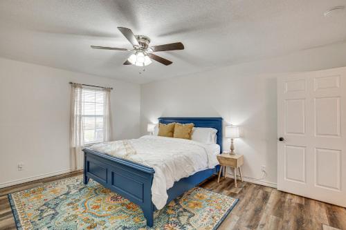 a bedroom with a blue bed and a ceiling fan at Van Vacation Rental with Private Lake Access and Dock in Van