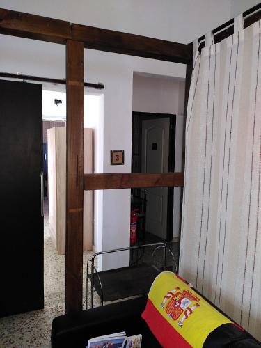 a living room with a couch and a curtain at Finca Caracol in Bolulla