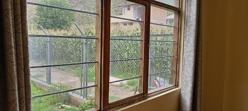 a window with a view of a yard at Casa de George in Urubamba