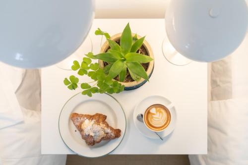a table with a plate of food and a cup of coffee at Vitaminas - Casa de Playa y Café in Punta del Este