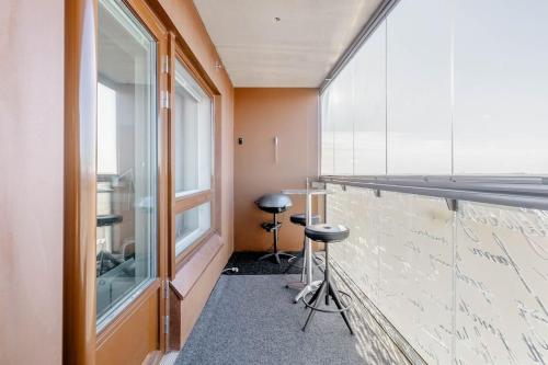 a room with a bar with stools next to a window at Tampere City view near Nokia Arena AC in Tampere