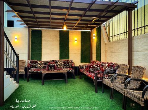 a patio with couches and a table and chairs at منتجع الكناري للفلل الفندقية الفاخرة Canary resort in Taif