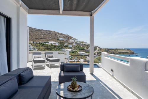 a living room with a view of the ocean at BLUE WATERS MYKONOS in Ornos
