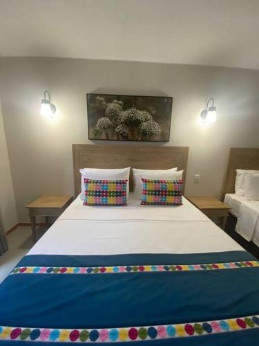 ein Schlafzimmer mit einem großen Bett mit zwei Kissen in der Unterkunft Eco Resort Quinta Santa Bárbara Ap 101/11 bloco E in Pirenópolis