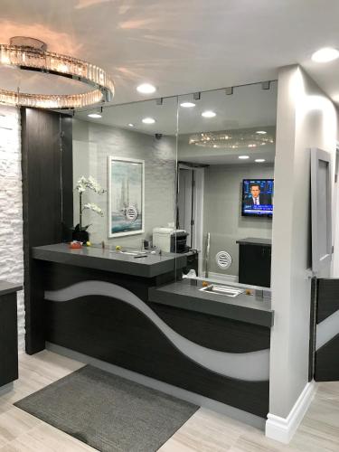 a lobby with a counter with a tv in a room at Sands Motel in Riverside