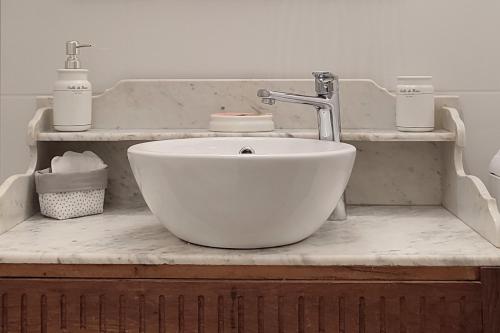 a bathroom with a bowl sink with a faucet at Blois City - Le Petit Louis XII in Blois