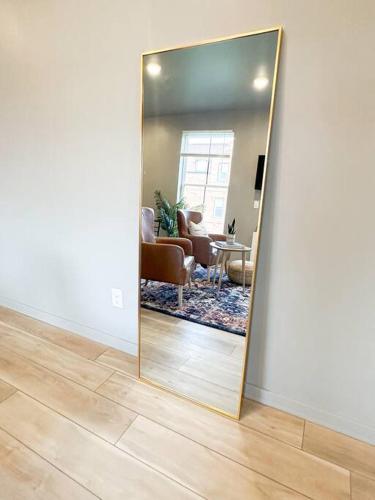 a mirror in a room with a living room at Stylish Cozy Studio in Detroit in Detroit
