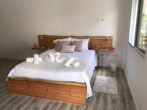 a bedroom with a large bed with white towels on it at Ninho do Monte in Ponta Delgada
