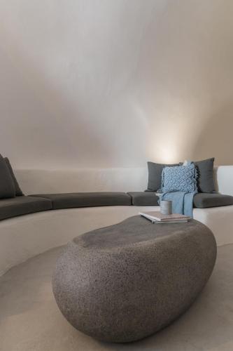 a living room with a couch and a large ottoman at Yposkafon Concept Two-Bedroom Villa with Private Jacuzzi and Hamam in Megalokhori