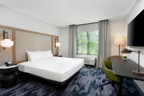a hotel room with a bed and a desk at Fairfield by Marriott Luquillo Beach in Luquillo