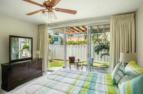 a bedroom with a bed and a ceiling fan at Beach Living at Island Pine Villas BLP in George Town