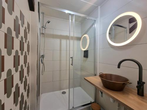 een badkamer met een glazen douche en een wastafel bij L'Expo in Hénin-Beaumont