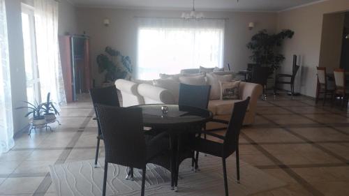 a living room with a table and a couch at Villa Cheval in Aukštadvaris