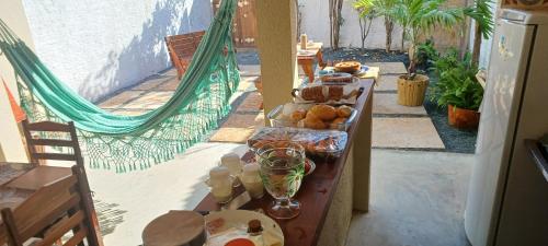 a table with food on it in a patio at Pousada Kasabela Residence in Prea