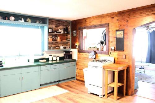 a kitchen with blue cabinets and a white stove at The Hunter Anderson in Mulberry