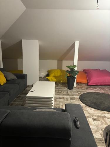 a living room with a couch and a table at Dom s bazénom a záhradou na dovolenku snov in Topoľníky