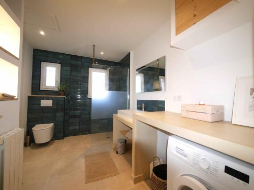 a bathroom with a sink and a toilet in a room at Villa succulente in Bouzigues