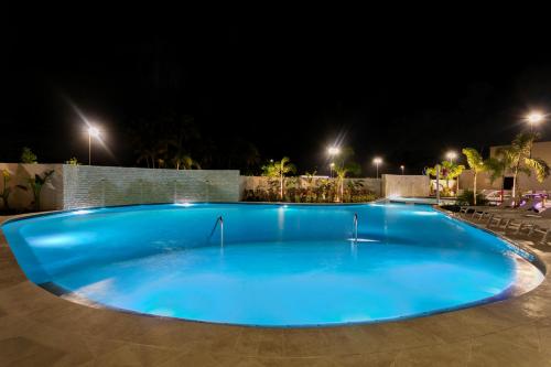 a large blue swimming pool at night at Fairfield by Marriott Luquillo Beach in Luquillo
