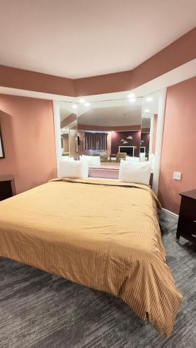 a hotel room with a large bed in a room at Inn of the Dove - Romantic Luxury Suites with Jacuzzi & Seasonal Fireplace at Harrisburg-Hershey-Philadelphia, PA in Harrisburg