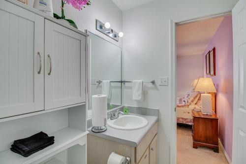 a bathroom with a sink and a mirror at Albuquerque Getaway Near Shopping and Fiesta Park! in Albuquerque