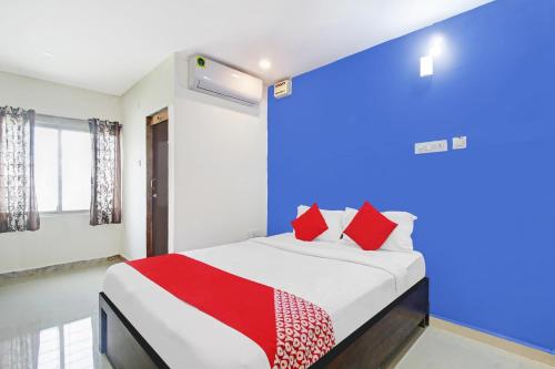 a bedroom with a large bed with red pillows at OYO Flagship A Delight Residency in Hyderabad