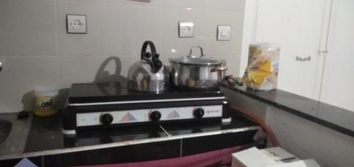 a kitchen with two pots and pans on a stove at Dar Fes Marrakech in El Hajeb