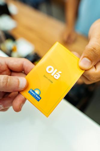 a person holding a yellow object in their hand at Days Inn by Wyndham Rio de Janeiro Lapa in Rio de Janeiro