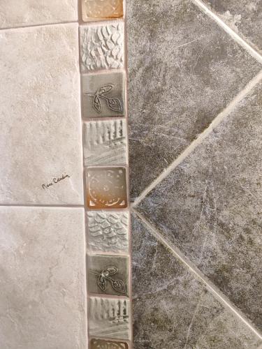 a tile floor with stones on top of it at Vasiliki house 1 in Vartholomio