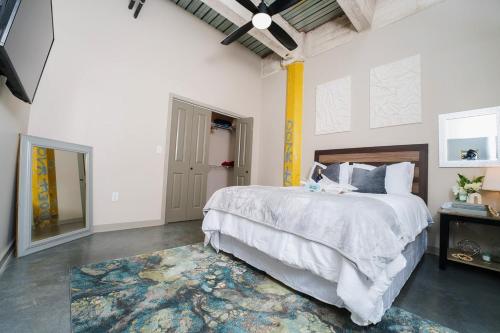 a bedroom with a large bed and a rug at Cozy Luxurious Loft in Downtown Memphis in Memphis