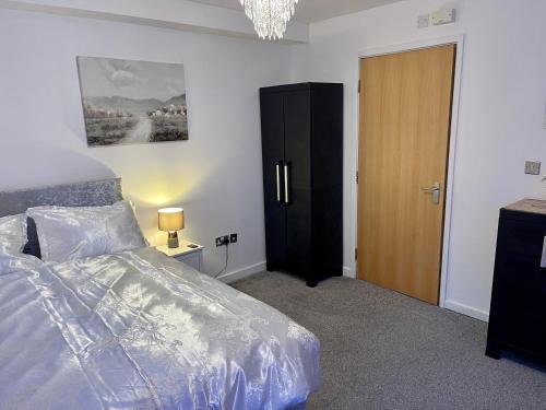 a bedroom with a bed and a wooden door at Elegant 1-BR Flat Roman Road in Middlesbrough