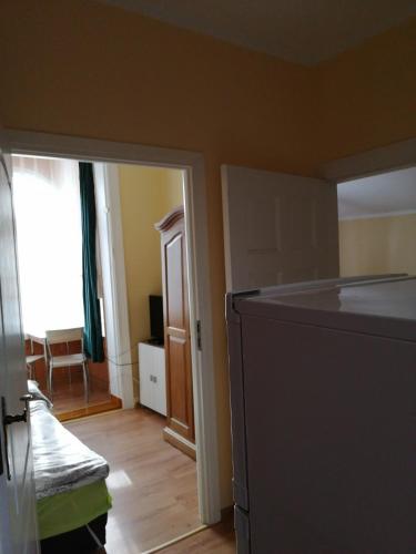 a kitchen with a refrigerator and a door to a room at Willa Wiselka in Wisełka