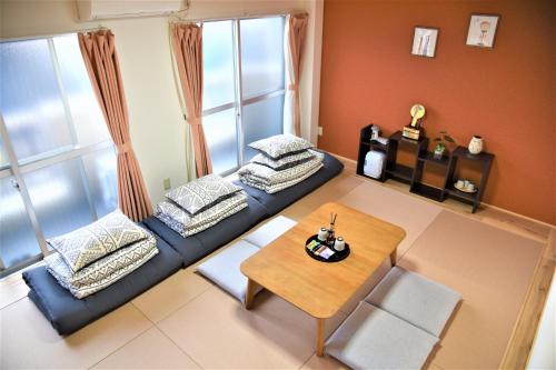 a living room with a blue couch and a table at YūshukuFushimi Inari - Vacation STAY 41351v in Kyoto