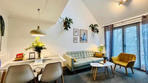 a living room with a couch and a table at Westgate Garden riverside in Canterbury