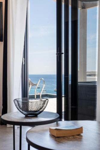 a room with a table and a basket on a table at BLUE WATERS MYKONOS in Ornos