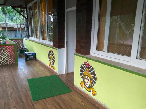 a front door of a house with a green rug at Samba Stay - Home away from home in Gokarna