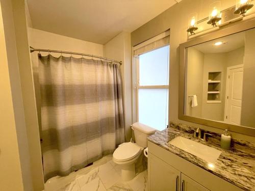 a bathroom with a toilet and a shower and a sink at 5-Bedroom Combined Apartment in King of Prussia! in King of Prussia