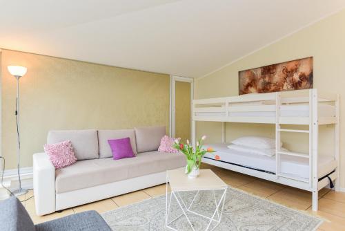 a living room with a couch and a bunk bed at Vila Laurus in Palanga