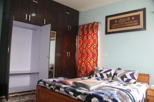 a bedroom with a bed and a mirror at Baba BabaBah in Srinagar