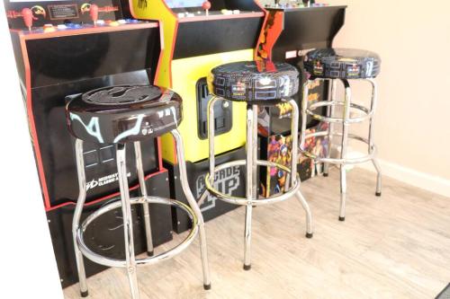 two bar stools in front of a guitar herostrumentaliststrument at Cowboy Den-Hot Tub-Game Room-Pet Friendly-No Pet Fees! in Albuquerque