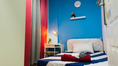 a room with a bed with a blue wall at Nicest Partition Room in Barsha Heights Near Internet City Metro in Dubai